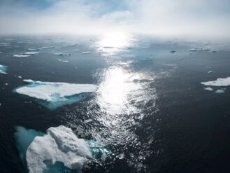 landscape and aerial photography of icebergs on body of water during daytime